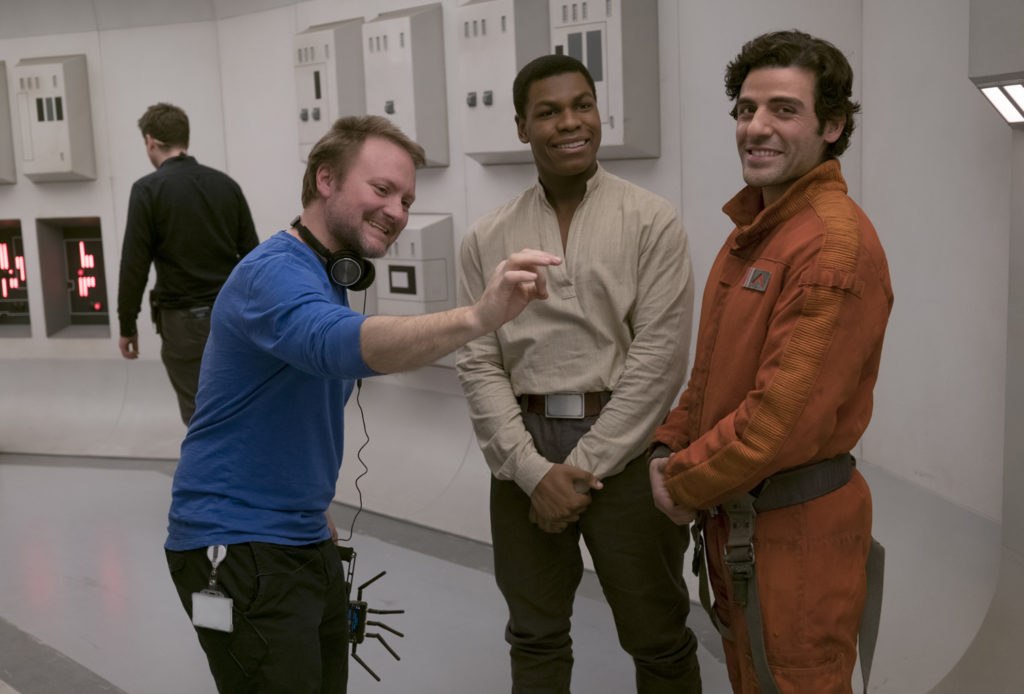 Director Rian Johnson on set with John Boyega (Finn) and Oscar Isaac (Poe Dameron).