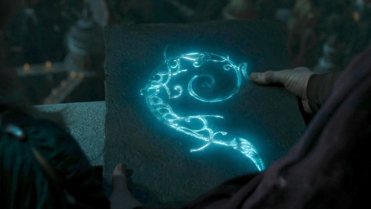 A glowing blue symbol on stone on The Rings of Power